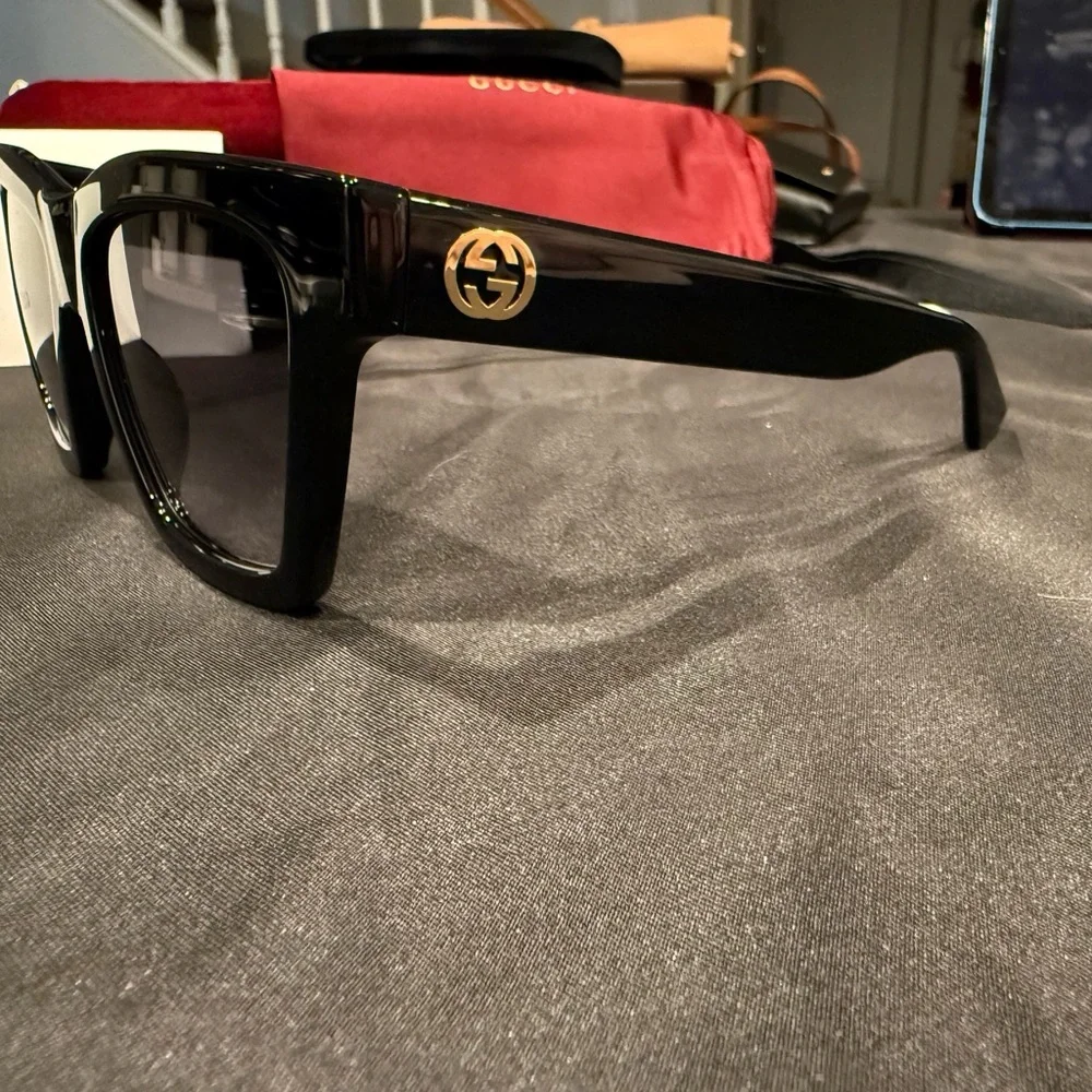 Gucci GG1714S cat-eye sunglasses with a black frame and solid grey lenses